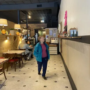 a woman walking down the hallway