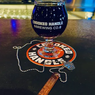 a glass of beer on a bar