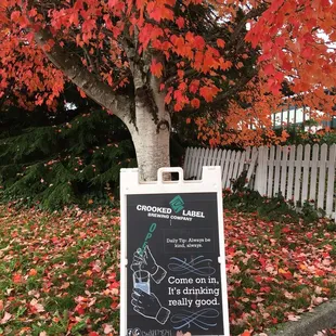 a sign in front of a tree