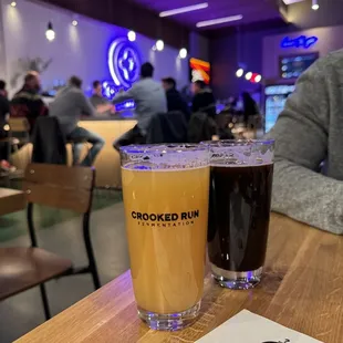 two glasses of beer on a table
