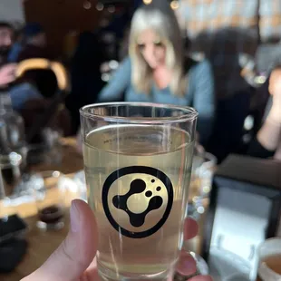 a person holding a glass of beer