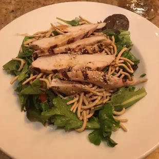 Asian chicken salad. Peppers, almonds, mandarin oranges, baby greens and grilled chicken