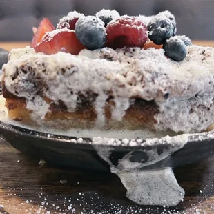 a cake with berries and powdered sugar