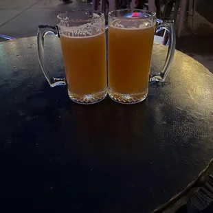 two glasses of beer on a table