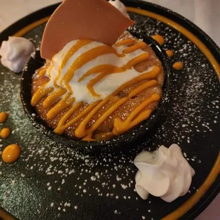 a dessert on a black plate