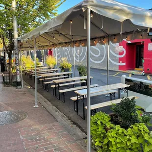 a row of tables with umbrellas