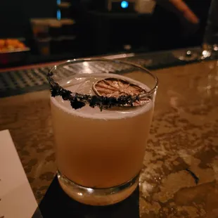 a glass of alcohol on a bar
