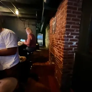 two people sitting at a bar