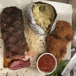 Saturday Special. Sirloin strip and shrimp with baked potato.