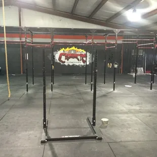 Main workout area with numerous pull-up stations and squat racks