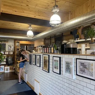 a woman standing in a coffee shop