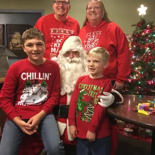 a family dressed in matching red shirts