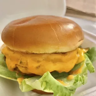 a cheeseburger with lettuce