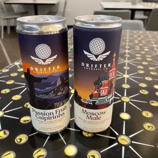 two cans of drink on a table