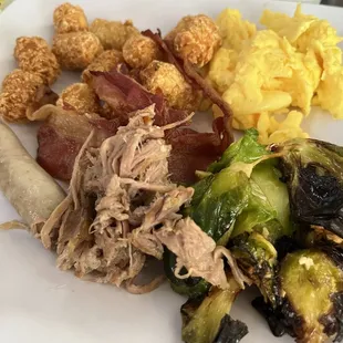 a plate of food with meat, potatoes, and brussels sprouts
