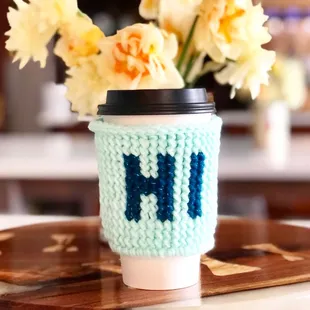 a knitted coffee cup cozyer