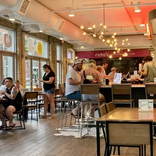 people sitting at tables in a restaurant