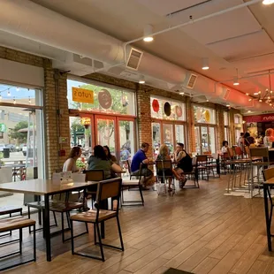 people sitting at tables in a restaurant