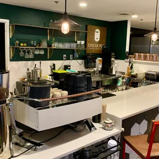 a coffee shop with a counter and chairs