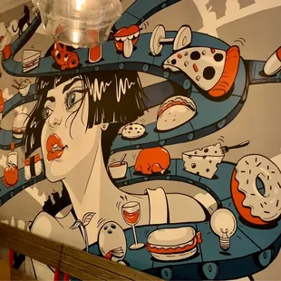 a mural of a woman with donuts