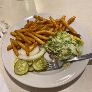 a plate of food with french fries and salad