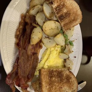 Crispy bacon, home fries, wheat toast and scrambled eggs.