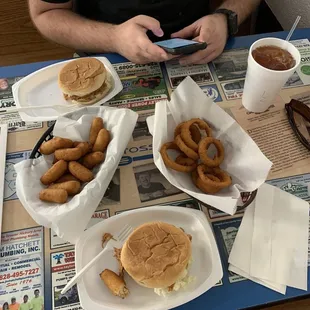 a man sitting at a table with plates of food
