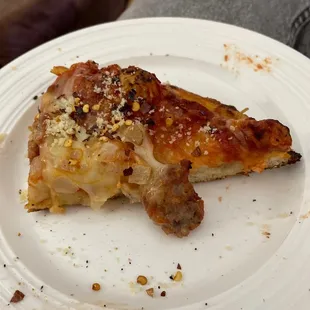 a half eaten piece of pizza