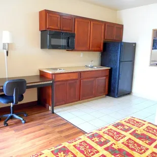 Work desk, Full Kitchenette, sink stove top, microwave and full size refrigerator and freezer