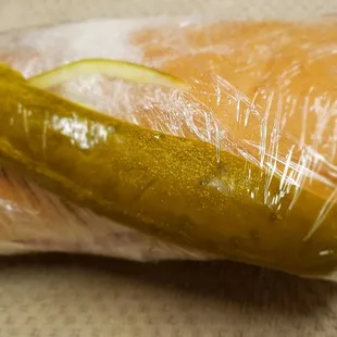 a pickle wrapped in plastic