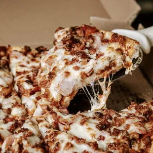 delicious meat pizza with pepperoni sausage ham hamburger and bacon