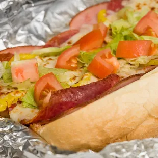 Italian sub made with ham, salami, pepperoni, onion, banana pepper, lettuce, tomato and love