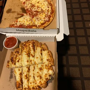 a pizza in a box with a slice taken out of it