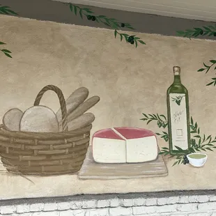 a basket of bread and a bottle of wine