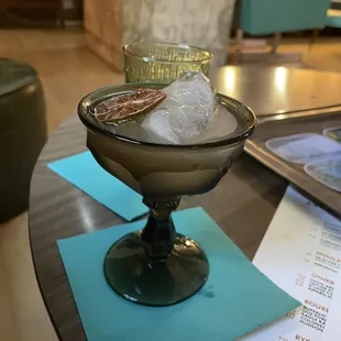 a glass of ice and a drink