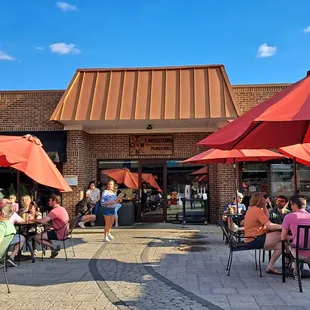 outdoor seating with red umbrellas