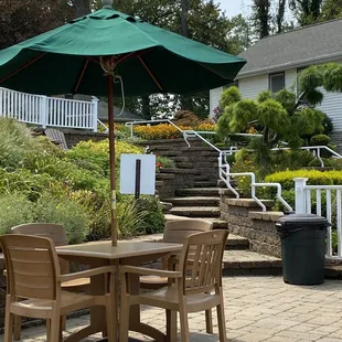 a patio with a table and chairs