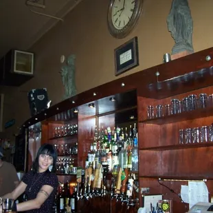 a woman behind a bar counter