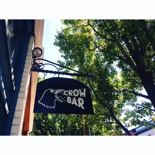 a sign hanging from the side of a building