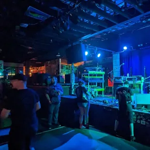 a group of people standing in front of a stage