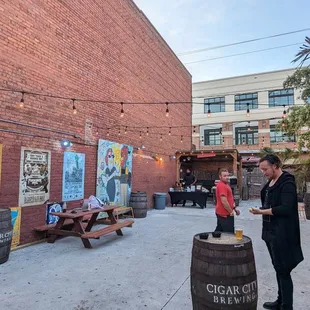 a man standing in front of a brick building