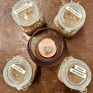 four jars of liquor with labels on them