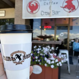 a hand holding a coffee cup