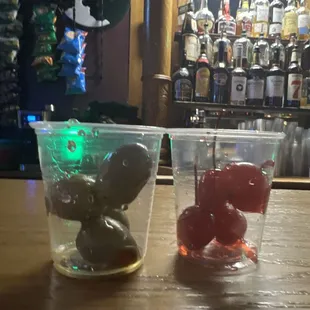 olives and cherries in a plastic cup