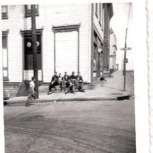 a group of people sitting on a curb