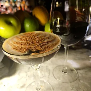 a glass of wine with a dessert in it