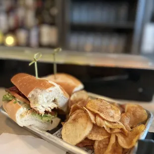 a sandwich and chips on a tray