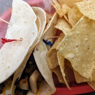 Chicken fajita tacos with cheese and tortilla chips