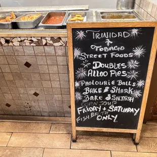 a menu board with a variety of food items