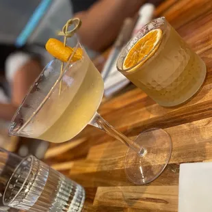 two cocktails on a wooden table